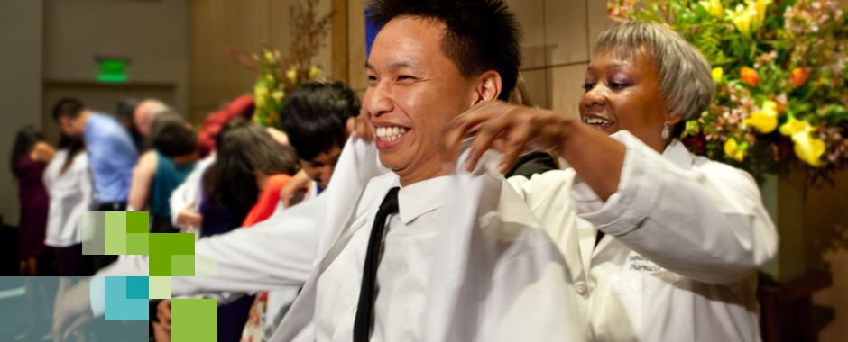 student pharmacist receiving white coat in ceremony