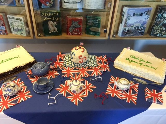 sheet cakes and a tea set laid out on a table decorated with British flags