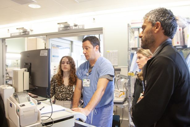 Gordon reviews data on a monitor in the Cardiac Critical Care Unit.