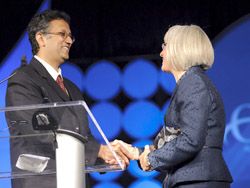 Roy accepts award.