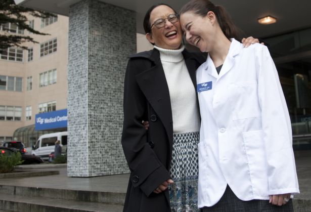 Mother and daughter on steps, laughing