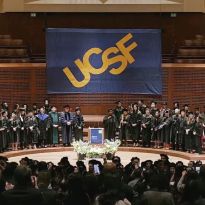 Davies stage with faculty, audience, and UCSF banners.