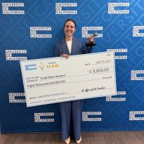 student with Grad Slam trophy