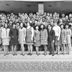 A group of men and women pose on the steps of a medical building