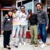 Zhou smiles with 4 people in front of barbershop