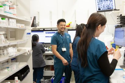 Kwong smiles with coworkers at UCSF Health Pharmacy Parnassus