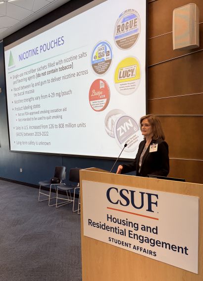 Corelli presents smoking cessation training at a podium