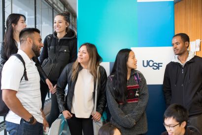 Students in front of a pillar with a "UCSF" banner