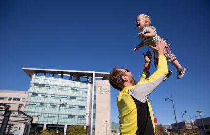 Man throwing child into the air