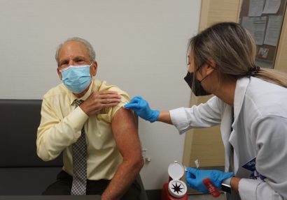 Guglielmo receiving a flu shot