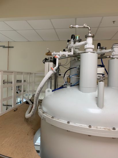 Helium collection pipes connected to an NMR spectrometer