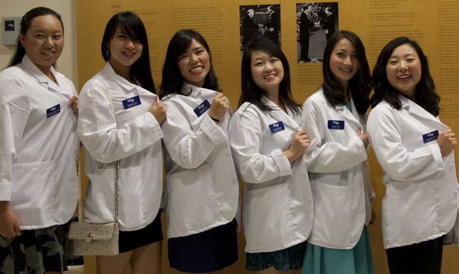 group of six students wearing white coats