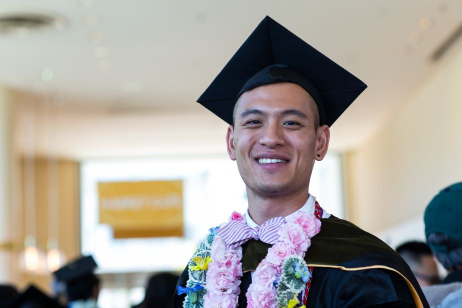 graduate with flower lei