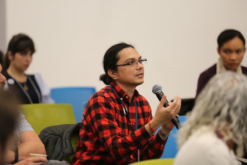 PSR Symposium audience member holding mic asks a question