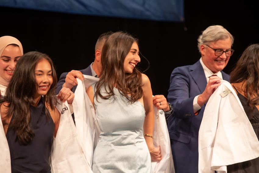 students being coated on stage
