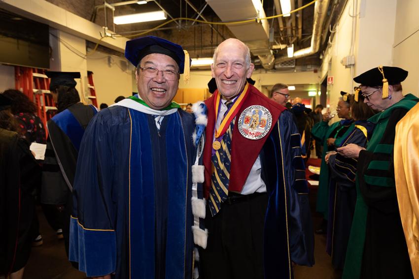 two smiling people at commencement
