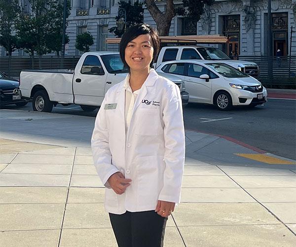 student wearing a pharmacy white coat 