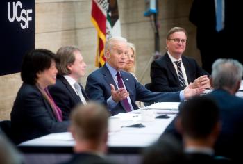 Biden sits on a panel with his wife, Jill, and UCSF Chancellor Sam Hawgood.