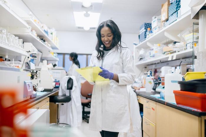 PharmD PhD student in pharmacy wearing white coat
