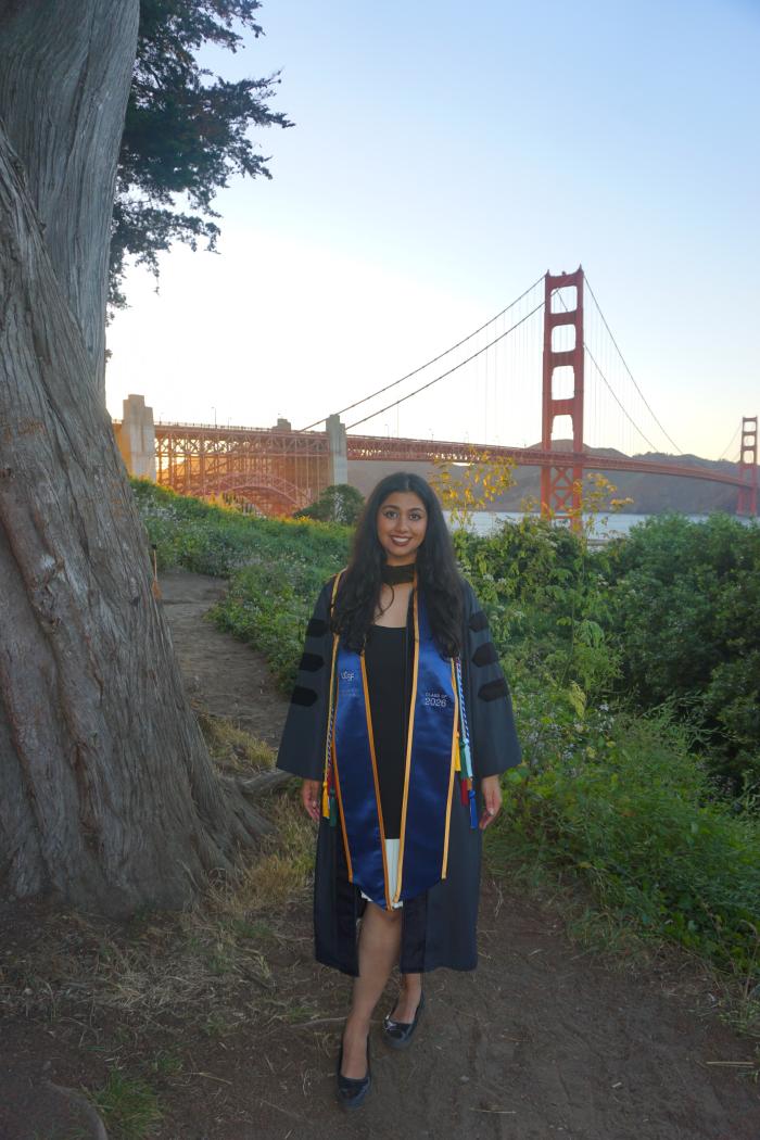 Rhea Misra in commencement gear with Golden Gate Bridge as backdrop