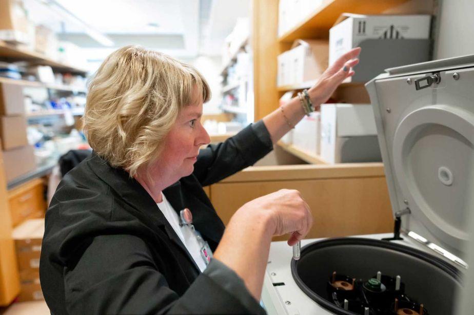 Janel Long-Boyle, PharmD, PhD working with a centrifuge